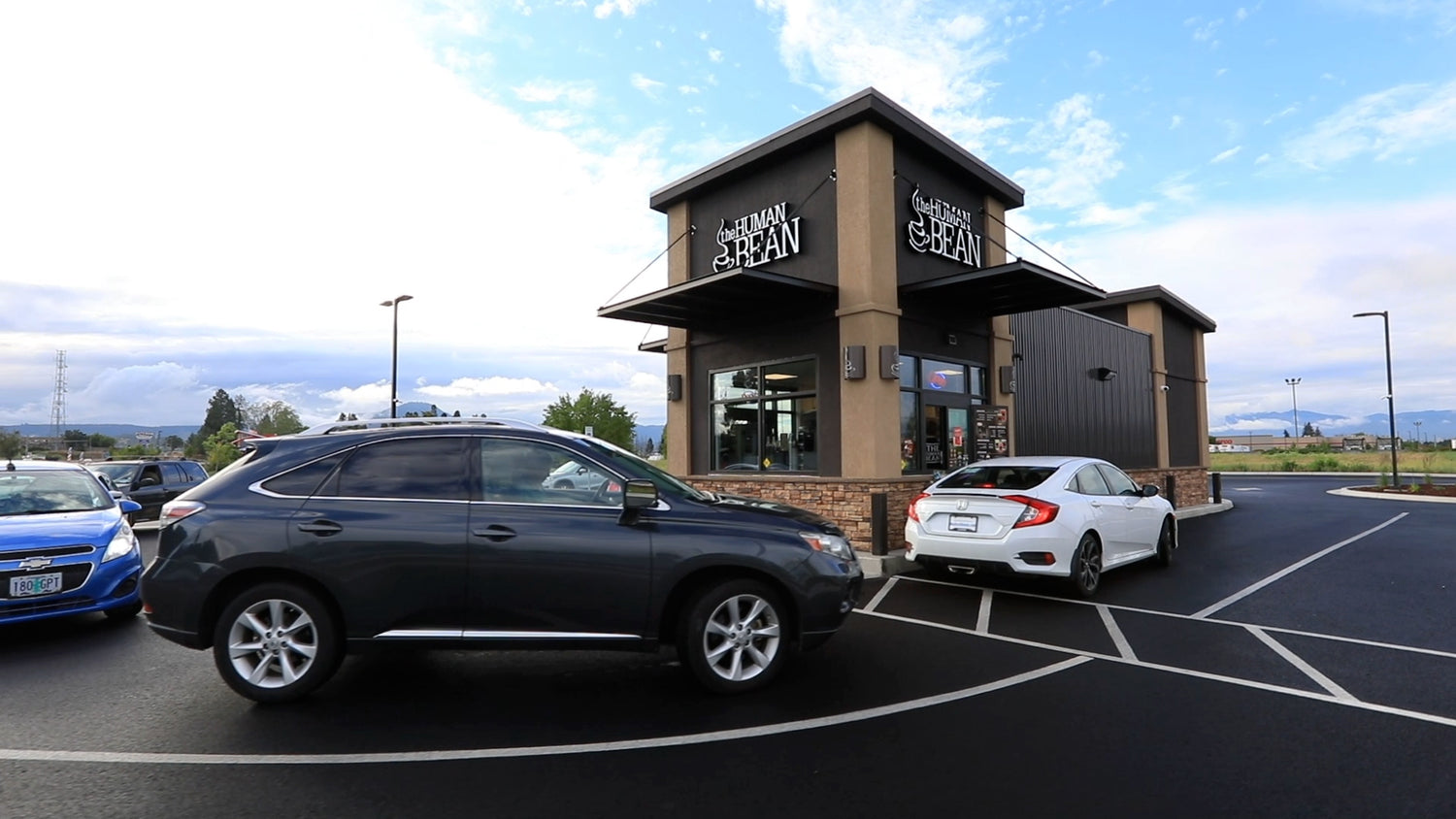 The Human Bean Coffee Drive Thru Store with Cars